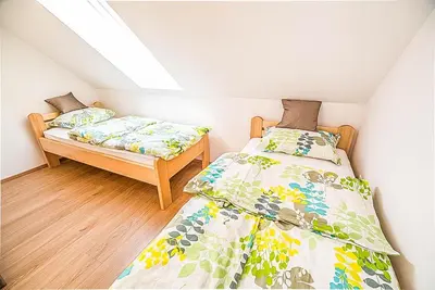 a bedroom with two beds in a attic at Holiday Home BOR in Podčetrtek
