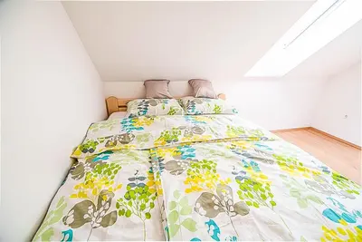a bedroom with a bed with a colorful comforter at Holiday Home BOR in Podčetrtek