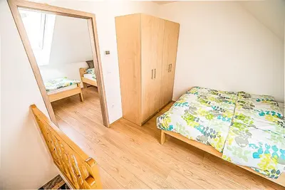 a bedroom with a bed and a mirror at Holiday Home BOR in Podčetrtek