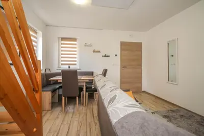a room with a table and chairs and a bed at Holiday Home BOR in Podčetrtek