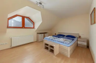 a bedroom with a large bed in a attic at Apartment Pr' Kavač in Rateče