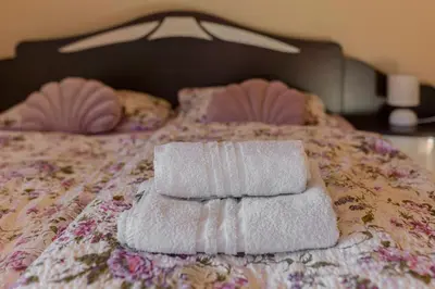 two towels sitting on top of a bed at Apartment Pr' Kavač in Rateče