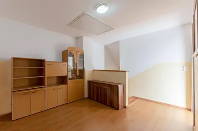 an empty room with wooden cabinets and a mirror at Apartment Pr' Kavač in Rateče