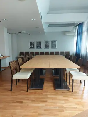 a large table and chairs in a room at Hotel Špica Laško in Laško