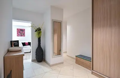 a living room with a mirror and a vase at Apartment Štros with private sauna in Kranjska Gora