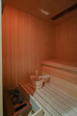a sauna with a toilet sitting on a wooden floor at Apartment Štros with private sauna in Kranjska Gora