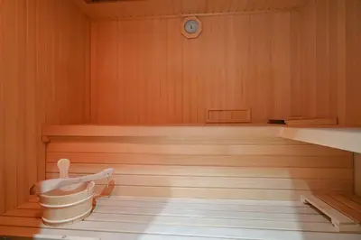 a room with a sauna with a bucket in it at Apartment Štros with private sauna in Kranjska Gora