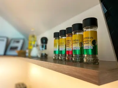 a row of bottles of oils sitting on a shelf at Apartment Landscape in Zgornje Gorje