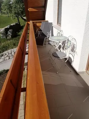 a wooden deck with a table and chairs on it at Apartment Landscape in Zgornje Gorje