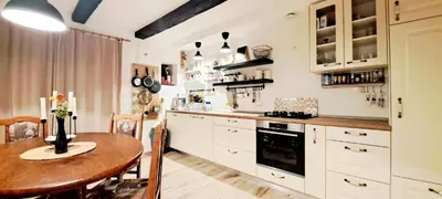 a kitchen with a wooden table and a dining room at RIVER KOLPA APARTMENT, Griblje ob reki Kolpi in Gradac