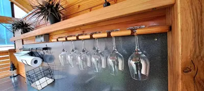 a bunch of wine bottles hanging on a wall at RIVER KOLPA APARTMENT, Griblje ob reki Kolpi in Gradac