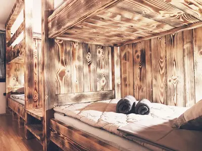 a large wooden bed with two pillows on it at RIVER KOLPA APARTMENT, Griblje ob reki Kolpi in Gradac