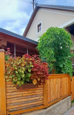 a wooden fence with two potted plants on it at RIVER KOLPA APARTMENT, Griblje ob reki Kolpi in Gradac