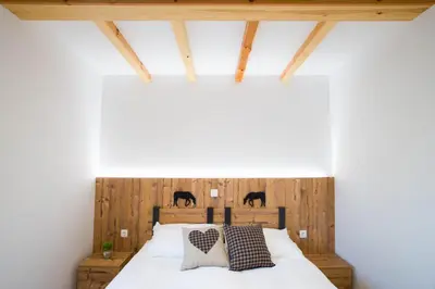 a bedroom with a bed with black horses on the wall at Pr Anzl in Bled