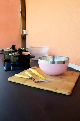 a bowl and knife on a cutting board next to a bowl at Camping Jakomin in Koper