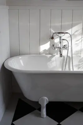 a white bath tub with a faucet in a bathroom at 9b-The Resort in Sežana