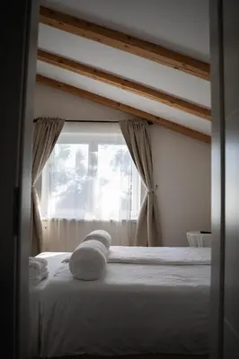 a bedroom with a white bed with a window at 9b-The Resort in Sežana