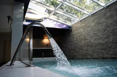 a water fountain in a pool in a building at 9b-The Resort in Sežana