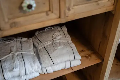 a pair of white mittens sitting on a wooden drawer at 9b-The Resort in Sežana