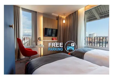 a hotel room with two beds and a large window at Holiday Inn Express - Ljubljana by IHG in Ljubljana