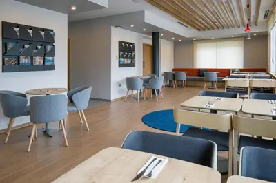 a dining room with tables and chairs and tablesktop at Holiday Inn Express - Ljubljana by IHG in Ljubljana
