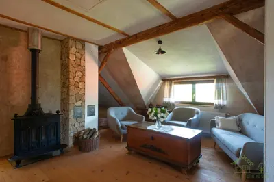 a living room with a couch and a stove at House of Culture and Nature - Hiša Kulture in Nature in Zagradec
