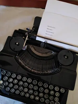 an old typewriter with a paper on top of it at House of Culture and Nature - Hiša Kulture in Nature in Zagradec