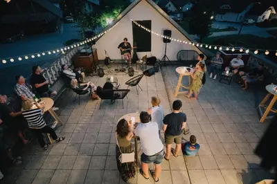 a group of people standing on a patio with a band at Hostel Gabronka in Bistrica ob Sotli