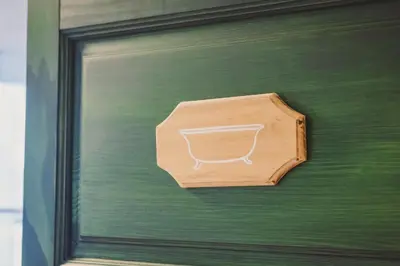 a wooden box hanging on a green wall at Hostel Gabronka in Bistrica ob Sotli