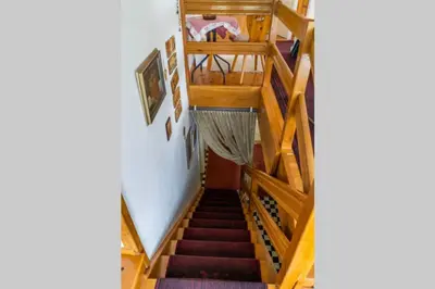 a staircase in a house with wooden stairs at APARTMA JANŠA in Bled