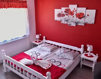 a red bedroom with a bed with a swan on it at Gostišče Trobej in Gornji Grad