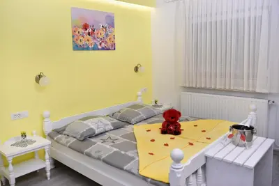 a teddy bear sitting on a bed in a bedroom at Gostišče Trobej in Gornji Grad