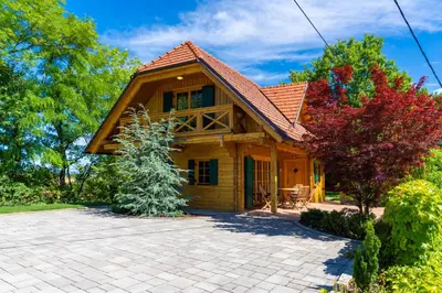 a wooden house with a brick driveway at Chalet Haloze in Pristava