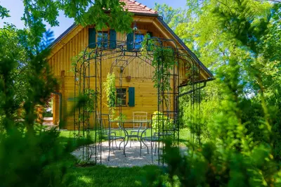 a house with a iron gate in front of it at Chalet Haloze in Pristava