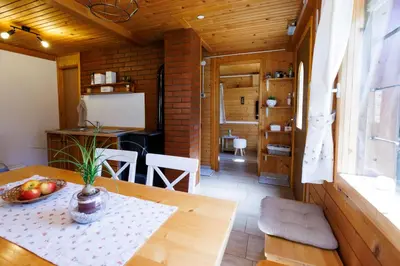 a kitchen and dining room with a table in a room at Počitniška hiša ErOs in Bohinj