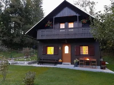 a small house with a gambrel roof at Počitniška hiša ErOs in Bohinj