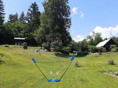 a net in the middle of a grass field at Počitniška hiša ErOs in Bohinj