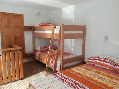 a room with two bunk beds and two beds at Apartma Kambrca in Drežnica
