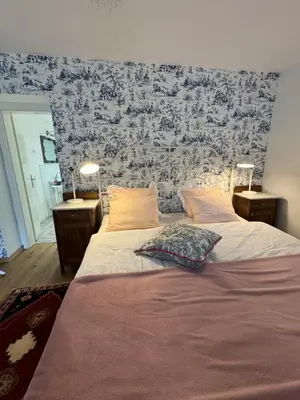 a bedroom with a large bed with two lamps on it at Historical Villa in the heart of Bled in Bled