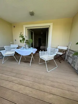 a patio with a table and chairs on a deck at Historical Villa in the heart of Bled in Bled