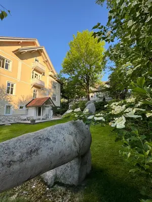 a stone bench in front of a house at Historical Villa in the heart of Bled in Bled