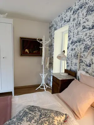 a bedroom with a bed and a blue and white wall at Historical Villa in the heart of Bled in Bled