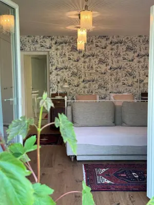 a living room with a bed and a wall at Historical Villa in the heart of Bled in Bled