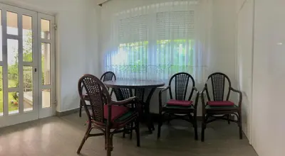 a dining room with a table and four chairs at Apartments Andrej - Optuj in Ptuj