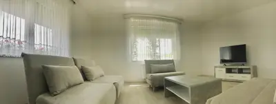 a living room with a couch and a tv at Apartments Andrej - Optuj in Ptuj
