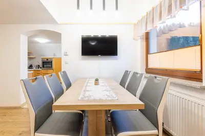 a dining room with a wooden table and chairs at Apartment Eli in Kranjska Gora