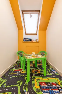 a childs room with a green table and chairs at Apartment Eli in Kranjska Gora