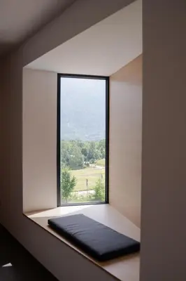 a window in a room with a black mat on a window sill at Hotel Soča in Bovec