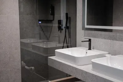 a bathroom with two sinks and a mirror at Hotel Soča in Bovec