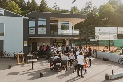 a group of people sitting outside of a building at Center Vintgar in Slovenska Bistrica